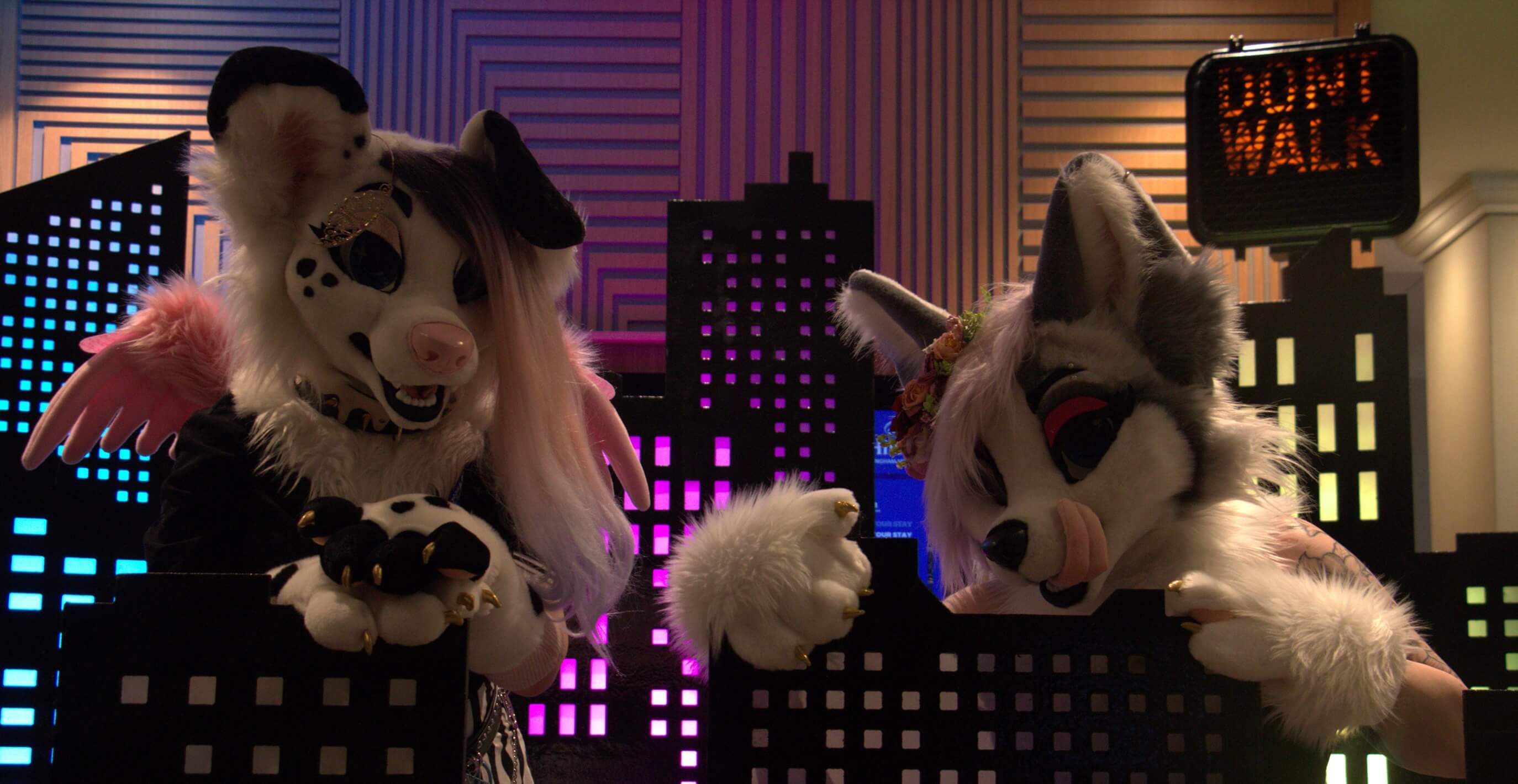 Two fursuiters modelling with scenary at ConFuzzled 2024